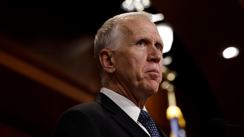 Sen. Thom Tillis (R-NC) listens to reporters during a news conference on Capitol Hill.