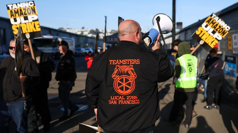 Teamsters union member holds protest sign