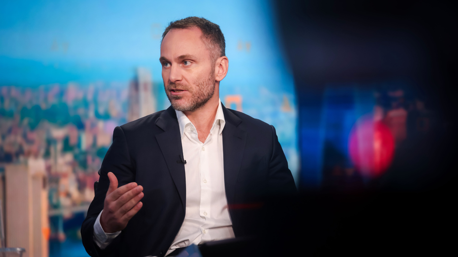 CEO of Tether Paolo Ardoino speaks to reporters during a televised interview.