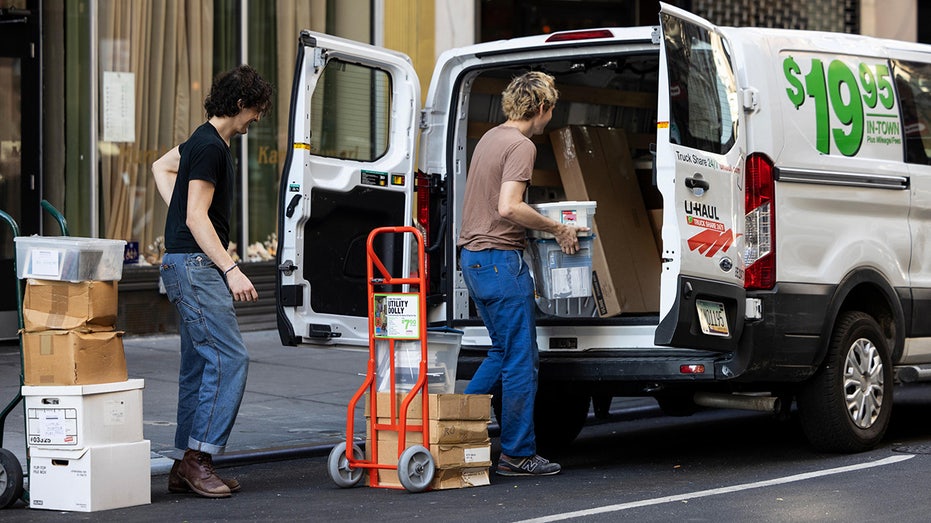 People load boxes into U-Haul van
