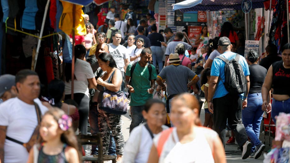 People walk through a neighborhood in Caracas, Venezuela.