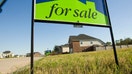 A for sale sign sits in front of a vacant lot near completed homes in a Missouri subdivision. - Fox Business News