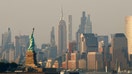 The sun sets on the Statue of Liberty and the Empire State Building in New York City on July 28, 2025, as seen from Bayonne, New Jersey. - Fox Business News