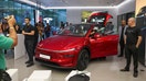 Media personnel take pictures and videos of the TESLA Model Y car at India's first Tesla showroom in Mumbai, India, July 15, 2025.  - Fox Business News