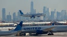 A United Airlines Boeing 777-224 airplane lands in front of the skyline of lower Manhattan and One World Trade Center in New York City at Newark Liberty International Airport on Jan. 29, 2026, in Newark, New Jersey.   - Fox Business News