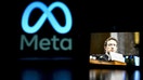 A computer screen displays the Meta logo while a mobile phone in the foreground shows Meta founder Mark Zuckerberg. Meta will lay off around 8,000 workers, the company said in a memo to employees.  - Fox Business News