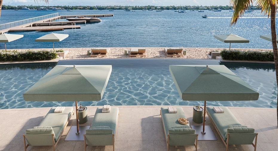 Infinity pool with lounge chair cabanas