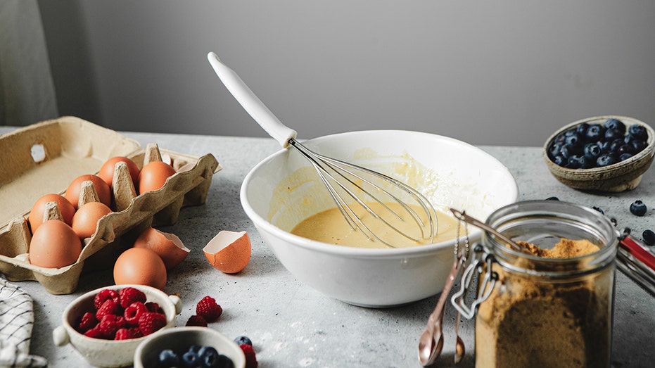 Close up of cake mix, eggs and berries