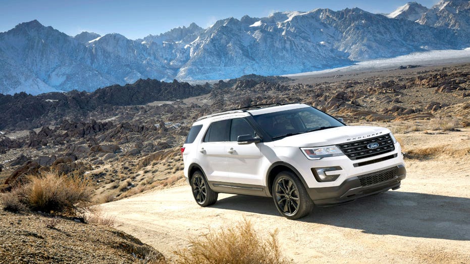Ford Explorer driving on a dirt road.