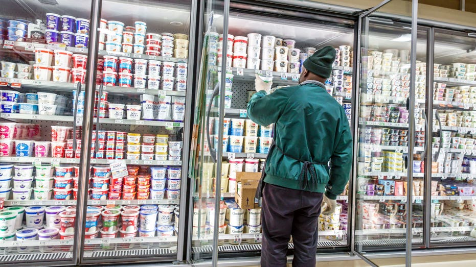 Publix employee in front of the dairy section.