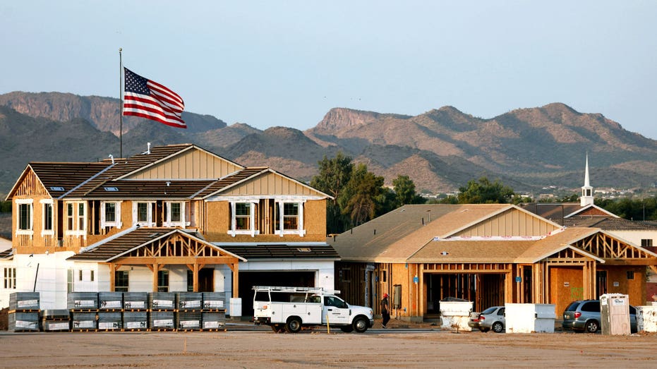 Homes under construction with mountains in the background.