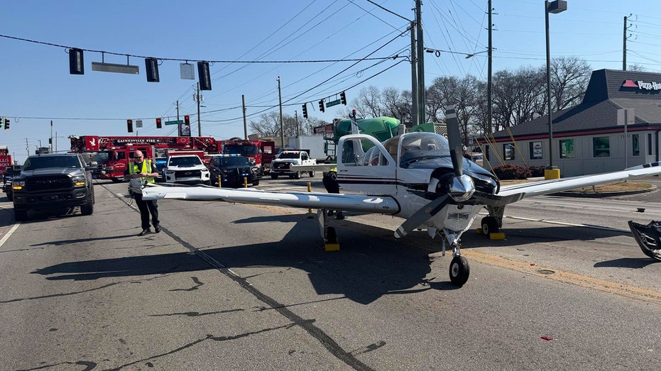 Damaged single-engine plane blocked traffic as police and fire crews respond.