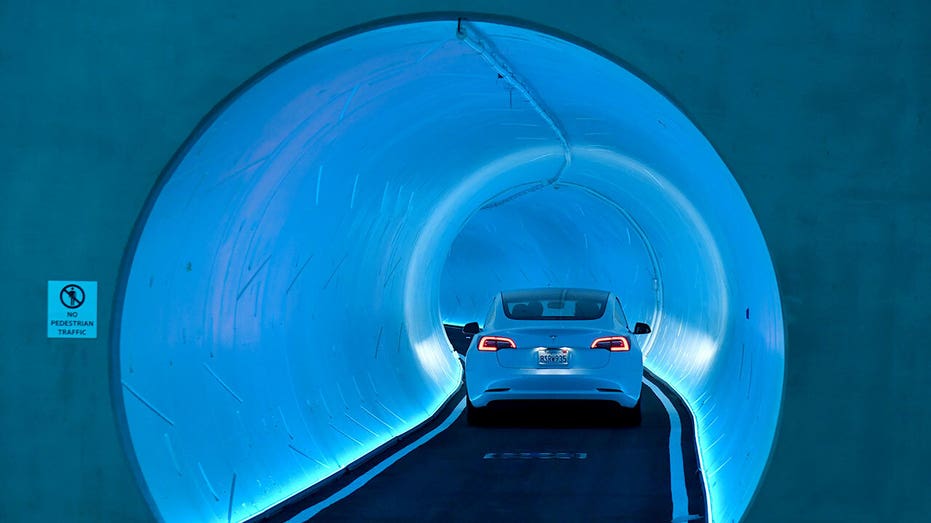 A Tesla car enters a tunnel.
