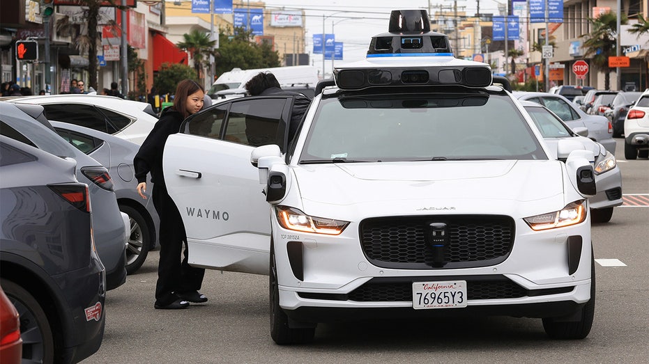 waymo vehicle picks up passenger