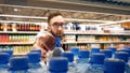 A shopper takes a plastic water bottle off a shelf at a grocery store. - Fox News