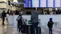 Travelers look at a flight information display board showing several flights cancelled due to weather at LaGuardia Airport in New York. - Fox News