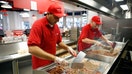 Chefs fry bacon on a griddle in the kitchen at burger restaurant chain Five Guys in London, U.K., on July 2, 2013.  - Fox Business News