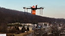 A "Grubhub" branded drone flies across a city. - Fox Business News
