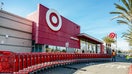 A worker moves shopping carts outside a Target store in Emeryville, California, US, on Thursday, Feb. 26, 2026. - Fox Business News
