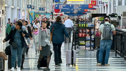 Air travelers walk on a concourse at Chicago O'Hare International Airport in the northwest side of Chicago, Illinois on January 15, 2026.  - Fox Business News