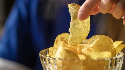 Eat classic thin potato chips salted crispy slices in a bowl - Fox Business News