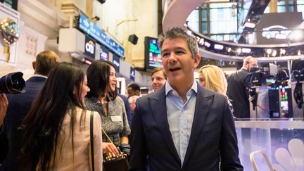 Travis Kalanick, founder and former chief executive officer of Uber Inc., center, stands on the trading floor during the company's initial public offering (IPO) at the New York Stock Exchange on May 10, 2019. - Fox Business News