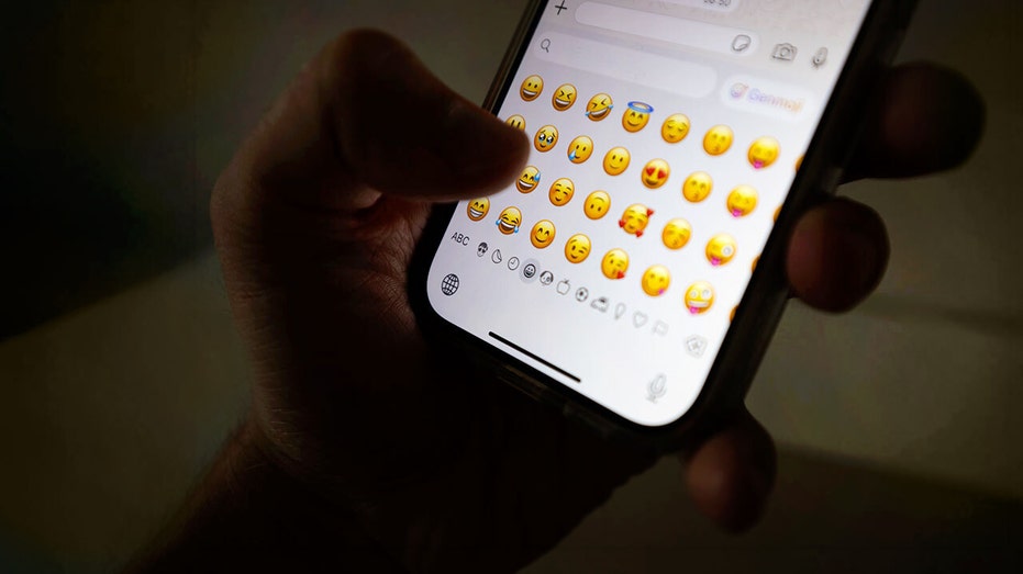 An Apple iPhone showing emojis.