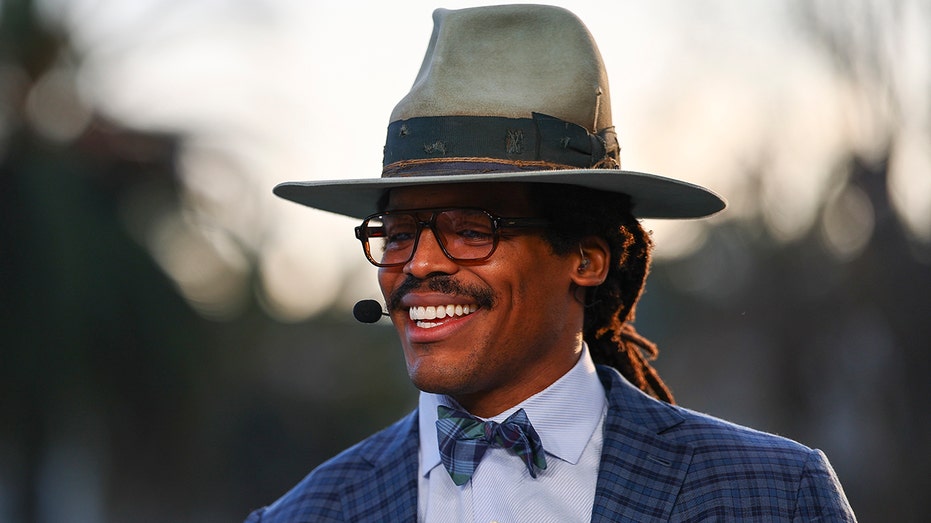 Cam Newton speaks into microphone