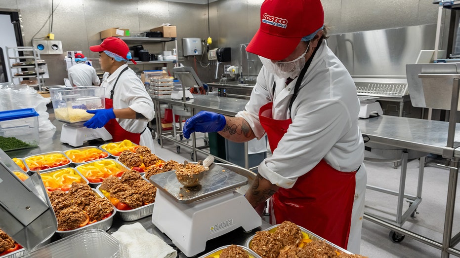 costco workers preparing ready to eat meals
