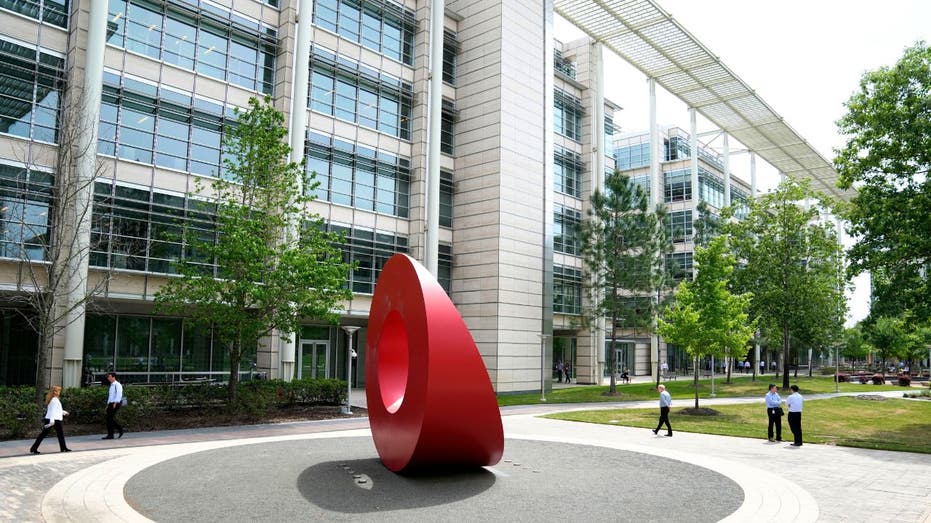 ExxonMobil headquarters campus in Spring, Texas, with red sculpture in front of office building.