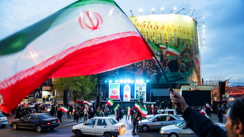 Iranian regime flags waving.