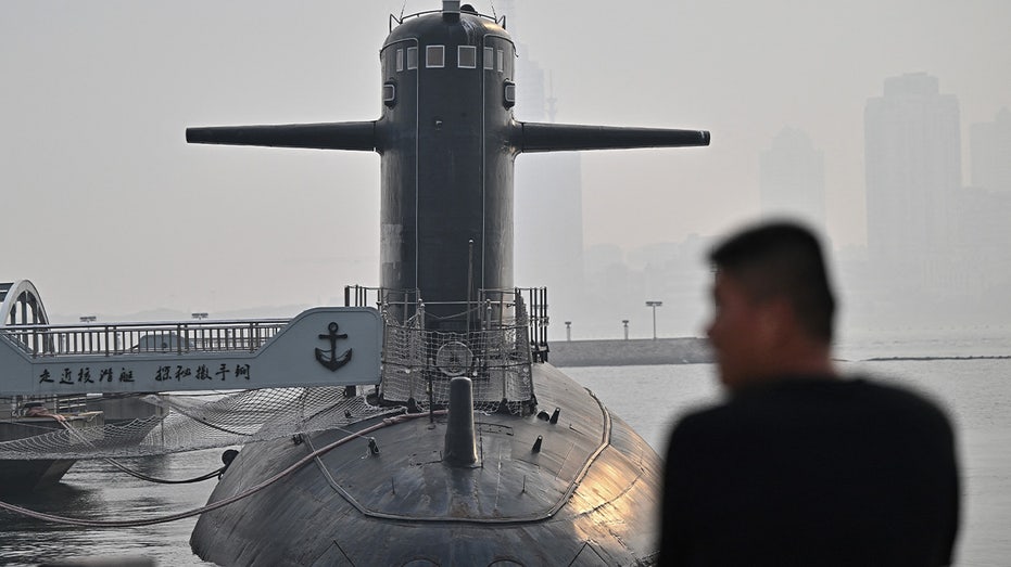 Man looks on at a Chinese submarine