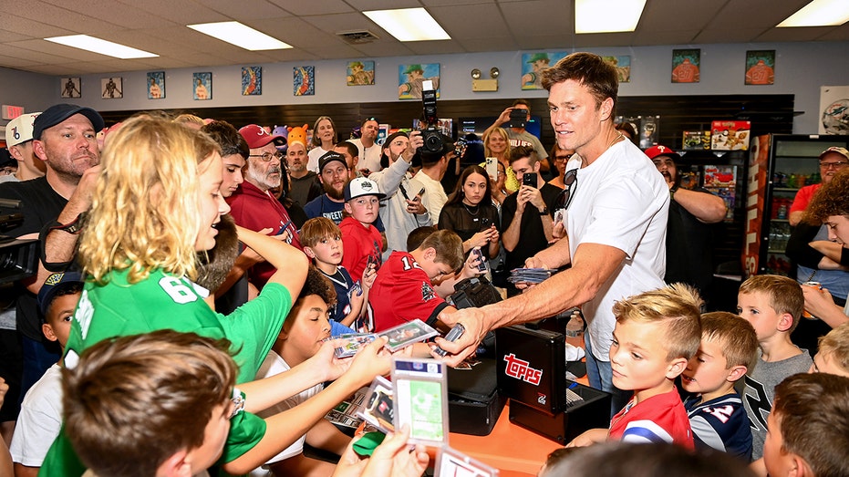 Tom Brady with kids at trading cards event