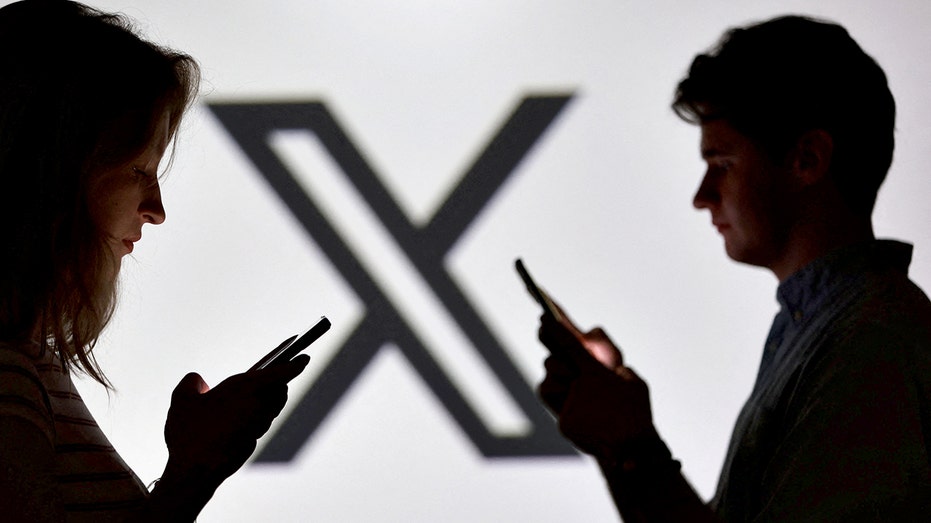 Teenagers hold phones with X logo
