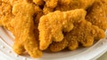 Cooked dinosaur-shaped chicken nuggets, a popular children&rsquo;s frozen food product, are displayed on a plate. - Fox News