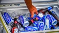A hand reaches into a cooler box to retrieve a can and bottle of Budweiser Light beer at the Port Huron Sailing regatta in Michigan - Fox News
