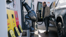 A man is seen pumping gas into his truck at a fuel station. - Fox Business News
