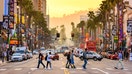 Pedestrians walk across Hollywood Boulevard in Los Angeles, California, at sunset. - Fox Business News