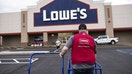 A worker moves empty carts outside a Lowe's store in Albany, New York, on Tuesday, Nov. 14, 2023. - Fox Business News