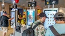 Customers using touchscreen kiosk ordering system inside McDonald's, Washington Avenue, Miami Beach, Florida. - Fox Business News