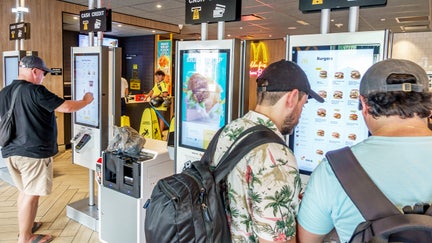 Customers using touchscreen kiosk ordering system inside McDonald's, Washington Avenue, Miami Beach, Florida. - Fox Business News