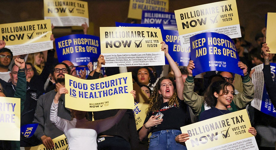 Protesters hold signs in support of billionaire tax