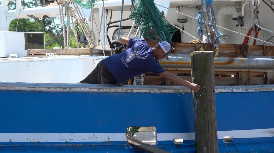 American shrimper works on shrimp boat