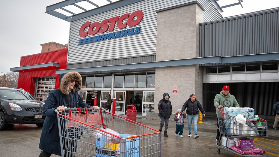 Customers with shopping carts outside Costco store