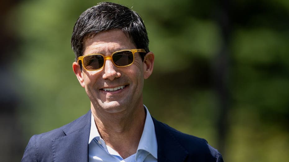 Kevin Warsh, former governor of the Federal Reserve, is seen leaving a conference. He will return to lead the central bank.