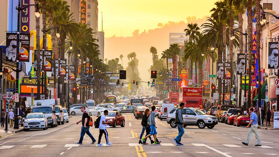 People walk along Hollywood Boulevard in Los Angeles