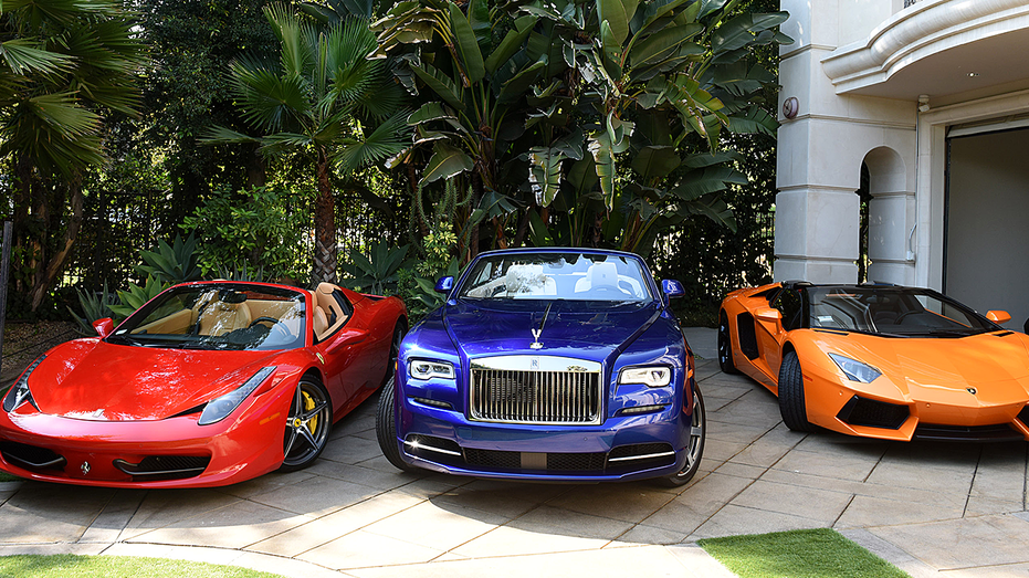 Luxury vehicles by pool