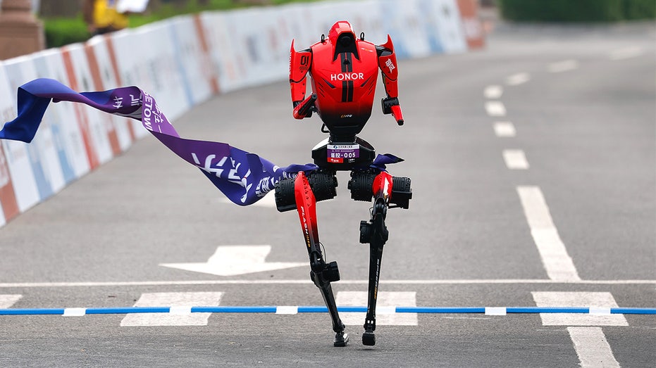 Humanoid robot crosses finish line during half-marathon in Beijing.