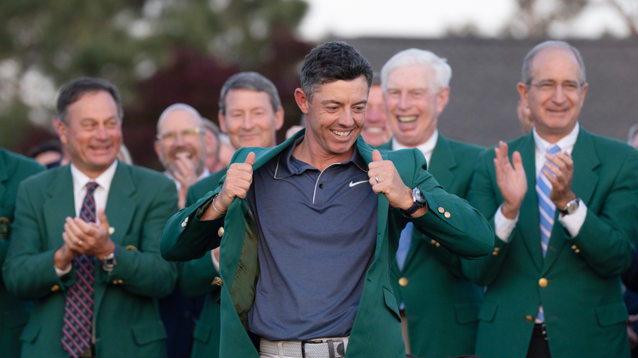 Professional golfer Rory McIlroy puts on his green jacket after winning the Masters tournament at Augusta National in 2025.