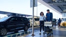 Travelers arrive at an airport pickup area - Fox Business News
